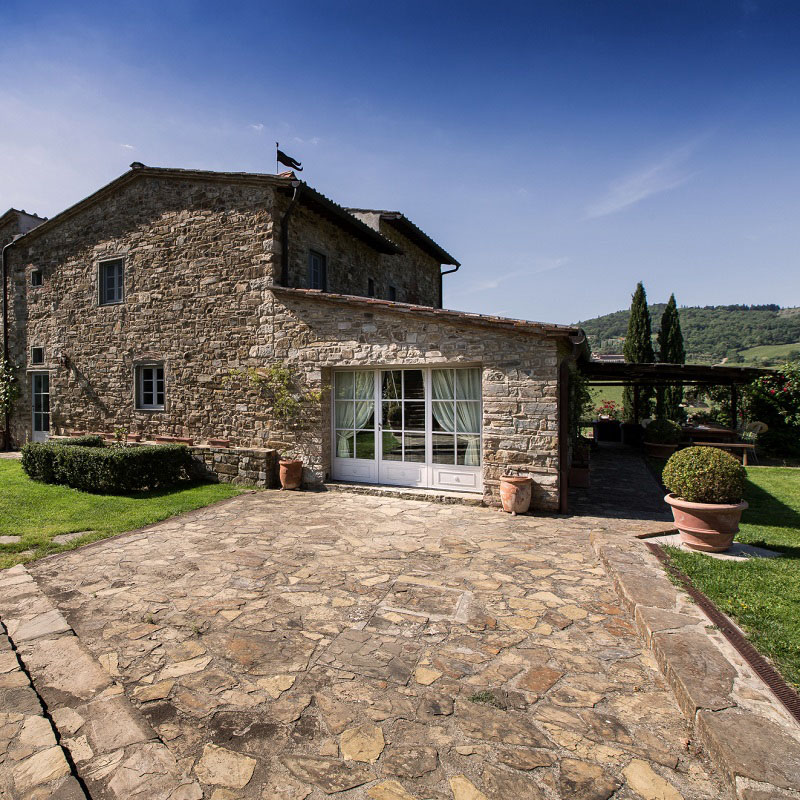 The exterior of a villa with dark antique stone